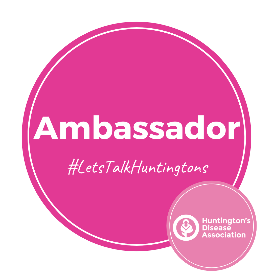 Pink circle with a white inner line and white writing in the middle that reads: Ambassador #LetsTalkHuntingtons. A smaller, light pink circle is to the bottom right of the main circle with the Huntington's Disease Association logo in the middle of the light pink circle